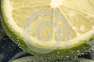 Slices of lime in a glass of soda water