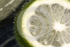 Slices of lime in a glass of soda water