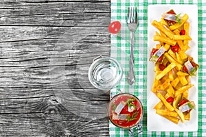 Slices of marinated Norwegian herring, Potato Fries, chili pepper, top view