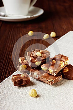 Slices of milk chocolate with nuts closeup