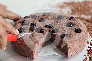 Slices of Navara rice vattayappam. Steamed rice cake made with a fermented batter of navara rice and coconut and steamed in a