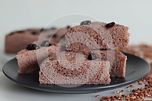 Slices of Navara rice vattayappam. Steamed rice cake made with a fermented batter of navara rice and coconut and steamed in a