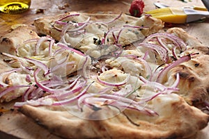 Slices of onion pizza on a wooden table, Italian traditional food