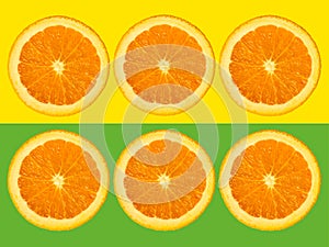 Slices of orange fruit isolated on colorful yellow and green pastel background - fresh modern minimalistic and creative image