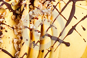 Slices of orange ice-cream with nuts close up.