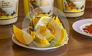 Slices of orange on a saucer with tequila mezcal bottles