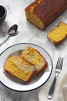 Slices of orange sponge cake and caramel