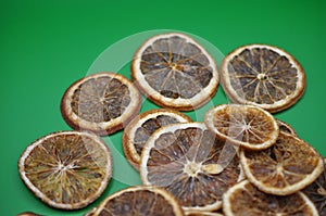 slices of oranges on green background