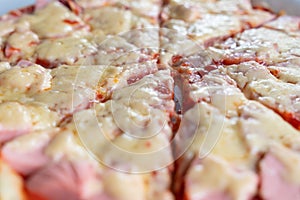 slices of pizza with melted cheese and sausage close-up as background