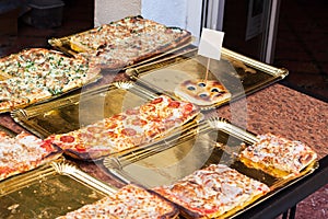 Slices of pizza for sale at Sineu market, Majorca