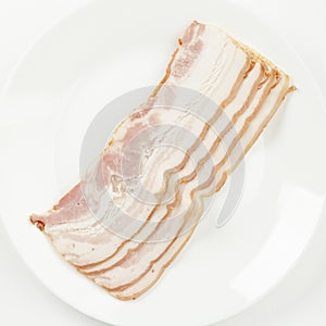 Slices of pork bacon or brisket on a white background