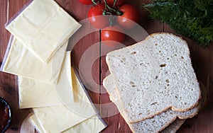 Slices of processed cheese with toast bread.