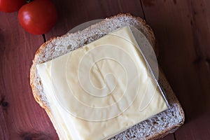 Slices of processed cheese with toast bread.