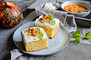 Slices of pumpkin cake topped with cream cheese  and Sea Buckthorn compote