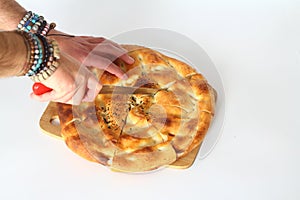 Slices of Ramadan Pita (Ramazan Pidesi) Traditional Turkish bread for holy month Ramadan on white background. photo