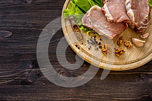 Slices of raw meat. Pork escalope on a wooden board.