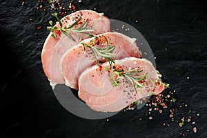 Slices of raw pork loin with the addition of aromatic herbs and spices