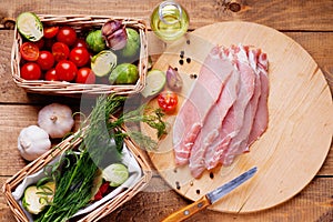 Slices of raw pork meat and vegetables