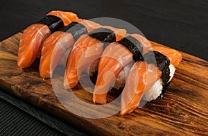 Slices of Raw Salmon Fillet on Black Background