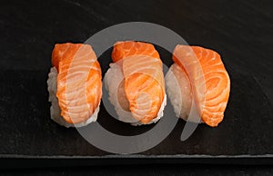 Slices of Raw Salmon Fillet on Black Background Mockup Top View