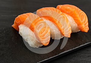 Slices of Raw Salmon Fillet on Black Background Mockup Top View