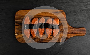 Slices of Raw Salmon Fillet on Black Background Mockup Top View