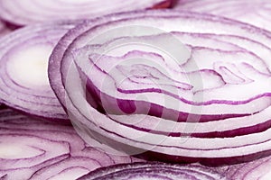 Slices of red onion on white background, close up