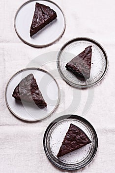 Slices of rich moist chocolate cherry cake. Homemade dark chocolate sweet brownies cakes