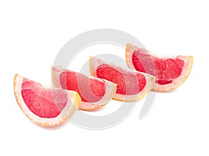 Slices of ripe and juicy grapefruit full of vitamins, isolated on white background. Citrus fruits concept.