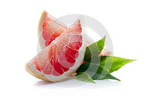 Slices of ripe and juicy grapefruit with green leaves close-up