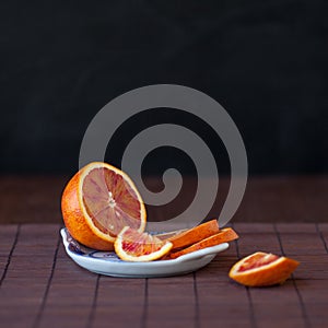 Slices of ripe orange on the saucer, close-up