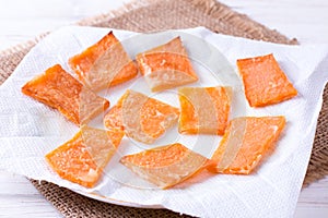 Slices of roast pumpkin on a paper napkin