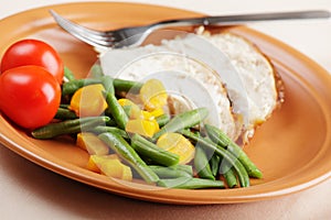 Slices of roasted turkey with vegetables