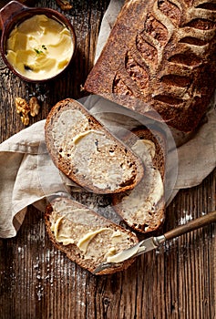 Slices of rustic homemade sourdough bread on wooden table, top view