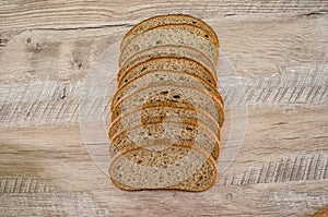 Slices of rye bread on a wooden background.