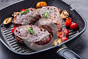 Slices of sirloin beef steak on meat fork on concrete background