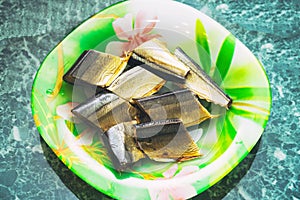 Slices of smoked saury fish on plate