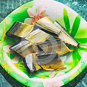 Slices of smoked saury fish on plate