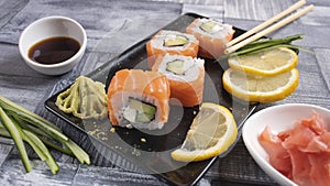 4 slices of sushi on torrels, soy, wasabi, ginger photo