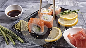 4 slices of sushi on torrels, soy, wasabi, ginger photo