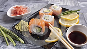 4 slices of sushi on torrels, soy, wasabi, ginger photo