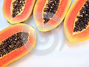 Slices of sweet papaya on white background