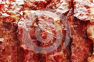 Slices of tasty fried bacon as background