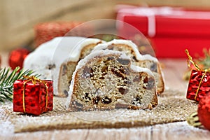 Slices of traditional German christmas season sweet food called `Stollen` or `Christstollen`, a fruit bread of nuts, spices