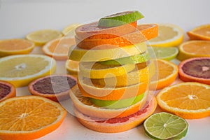 Slices of various citrus types arranged in a colorful stack