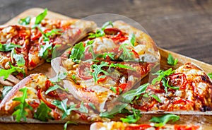 Slices vegetarian Pizza with Mozzarella cheese, Tomatoes, pepper, Spices and Fresh arugula. Italian pizza. Pizza Margherita or Mar