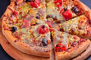 Slices of Vegetarian wood fired pizza on wooden board