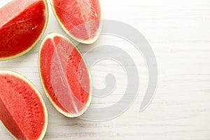 Slices of watermelon on white wooden table