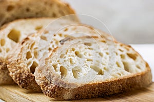 Slices of wheat bread on board close up