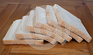 Slices of white bread on a kitchen table photo